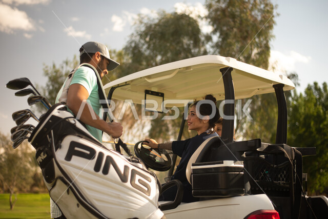 A Saudi Gulf Arab family on the golf course, an electric car specialized in transporting passengers, sports activities in Saudi Arabia, golf practice on large green areas, the game of golf, the Summer Olympics sports, recreational activities, the golf cou