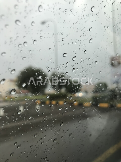 Water droplets on a glass window, rainy atmosphere, glass background with dew drops, winter atmosphere, heavy rain