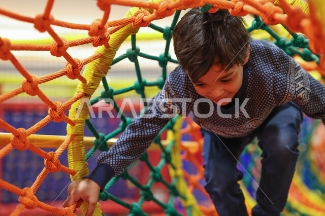 A close-up of a Saudi Arab Gulf child enjoying playing, entertaining and entertaining, recreational activities, happy summer vacation, spending fun times, children's games