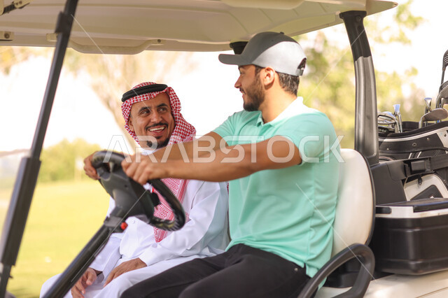 رجلان عربيان خليجيان سعوديان داخل سيارة كهربائية مختصة بنقل الركاب، لعبة الغولف ( الجولف ) ، أنشطة رياضية بالسعودية، رياضات الألعاب الأولمبية الصيفية، أنشطة ترفيهية، ملعب الجولف، نادي الجولف، عربة الجولف