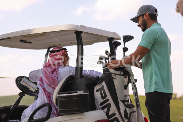 Two Saudi Arabian Gulf men on the golf course, an electric car specialized in transporting passengers, playing golf on large green areas, sports activities in Saudi Arabia, golf, Summer Olympics sports, recreational activities