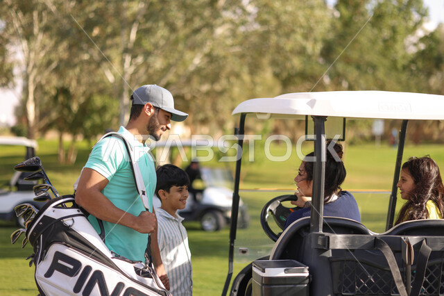 A Saudi Arab Gulf family in the golf course, playing golf on large green areas, sports activities in Saudi Arabia, golf, summer Olympics sports, recreational activities, an electric car specialized in transporting passengers, the golf course