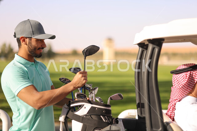 Saudi Arabian Gulf man on the golf course, getting ready to play golf, golf bag, sports activities in Saudi Arabia, golf (golf), Summer Olympics sports, recreational activities, golf course