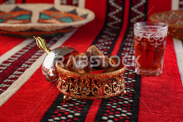 Close-up of a cup of tea, hot drinks, serving tea, a plate of dates, hospitality and reception, Arab hospitality