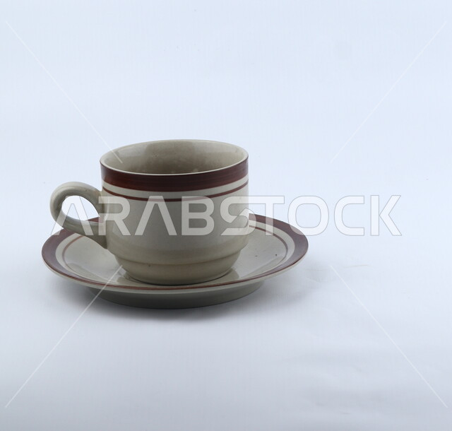 Close-up of an empty coffee cup, a ceramic cup, tableware, a tea cup, a cup for hot drinks, a white background