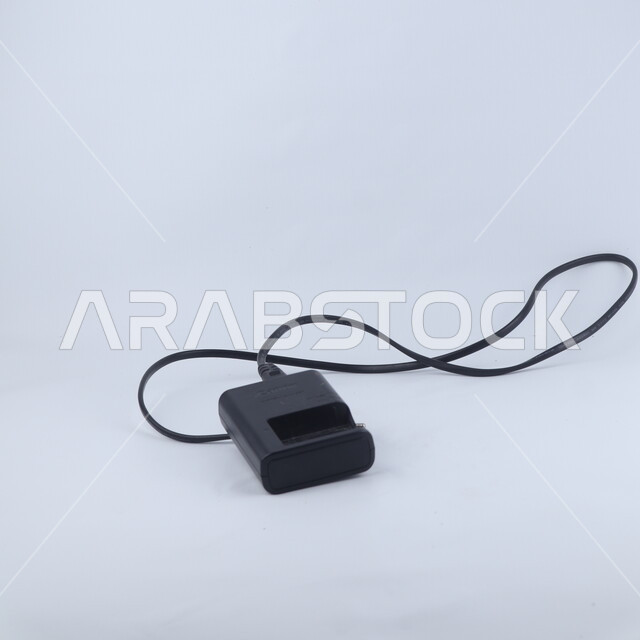 Isolated battery charger on a white background, electrical equipment and tools