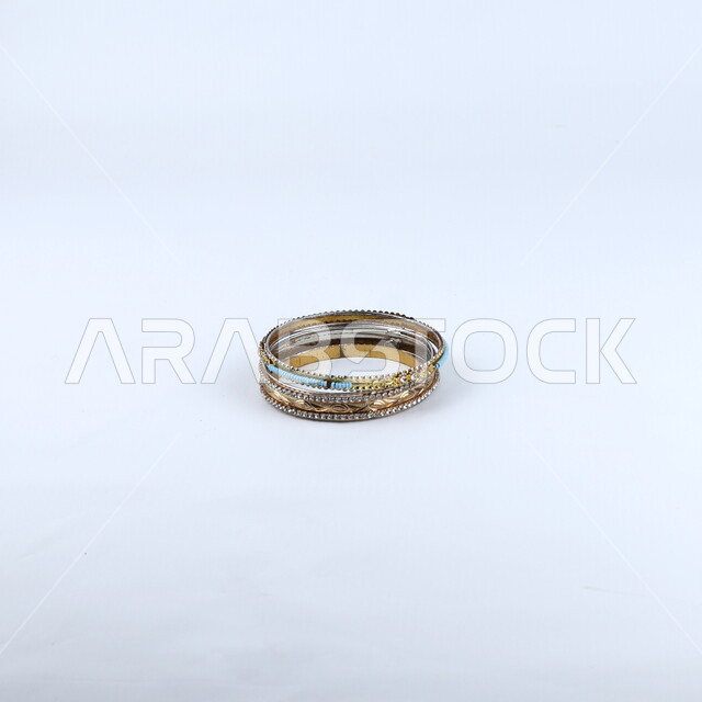 سوار ذهبي معزول على خلفية بيضاء ، إكسسوارات نسائية ، غوايش 