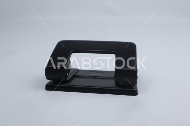 آلة ثفب الورق اليدوية، أدوات مكتبية، ثاقبة ورق سوداء اللون، قرطاسية، خلفية بيضاء