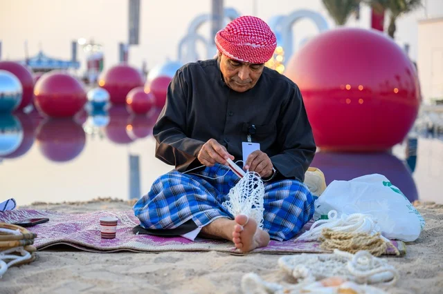 Qatari Craftsman Weaving Fishing Net in Doha - Photo