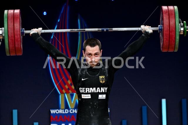 Roberto Gutu of Germany reacts after competing in clean & jerk, in the ...