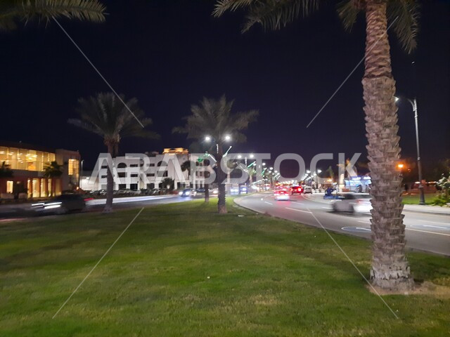 Car traffic on Jeddah Corniche Road, the waterfront in Jeddah, Saudi Arabia, and tourist attractions at night in Jeddah.