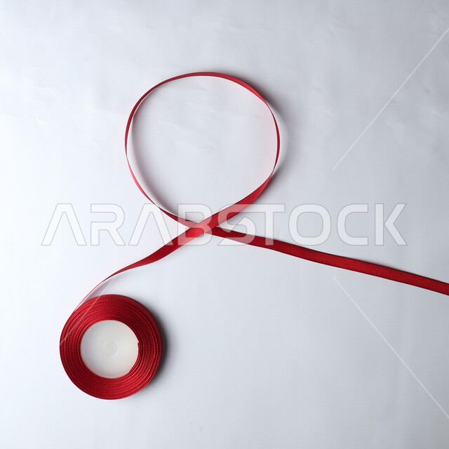 Red ribbon on a white background, HIV awareness, World AIDS Awareness Day, white background.