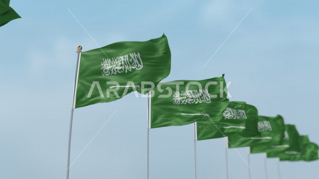 A group of Saudi flags in rows fluttering in the sky of the Kingdom at daytime, the Saudi national flag fluttering high, celebrating the Saudi National Day, the Kingdom’s National Day, the banner of monotheism and Islam, the Kingdom of Saudi Arabia