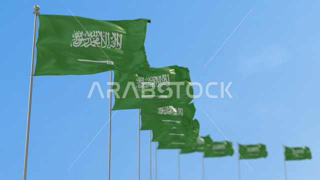 A group of Saudi flags in rows fluttering in the sky of the Kingdom at daytime, the Saudi national flag fluttering high, celebrating the Saudi National Day, the Kingdom’s National Day, the banner of monotheism and Islam, the Kingdom of Saudi Arabia