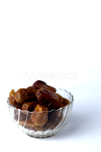 Close-up of a plate of healthy diabetes dates, a meal with a high nutritional value, Ramadan hospitality, types of healthy and delicious dates, white background