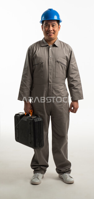 Portrait of a Filipino architect wearing a protective helmet and carrying a tool bag in his hand, construction worker, hand tool bag, finishing tools, smiling face gestures, recruiting labor from abroad, full-length body image, white background