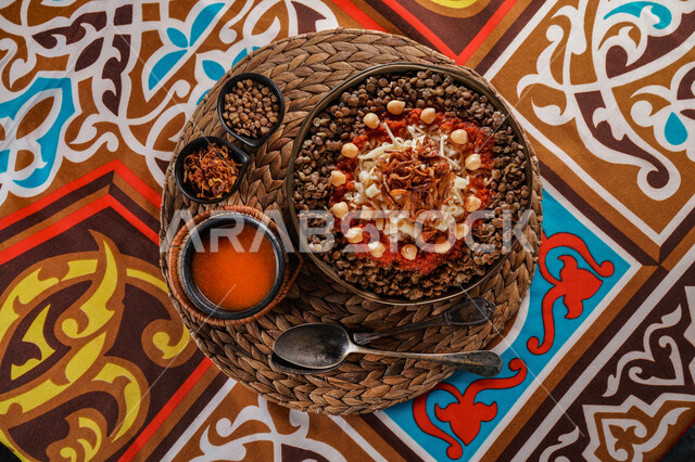 طبق من الكشري المصري الشهير، أطباق شعبية تقليدية، مائدة طعام، مطاعم عربية شرقية، وصفات وأطباق طعام لذيذة، طبق من الارز والمعكرونة المزينة بالصلصة الحارة 