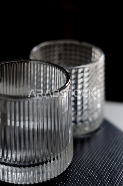 كوب زجاجي فارغ على خلفية سوداء , كأس كريستال , كوب ماء شفاف . 