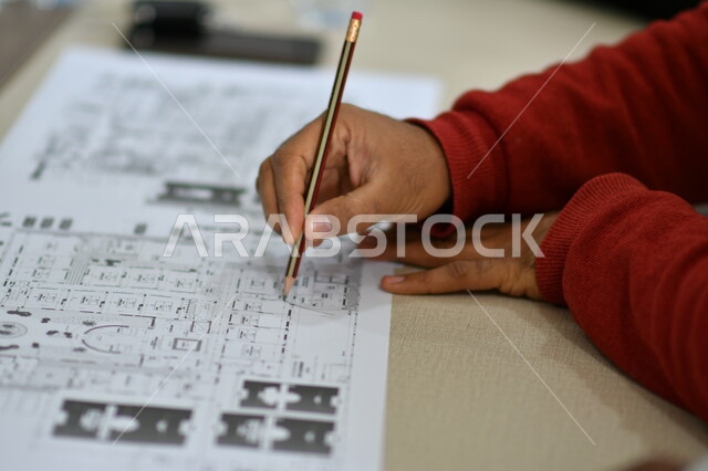 Close up of architect hand holding pen, design map, engineering project management, engineering concept, blueprints and engineering designs