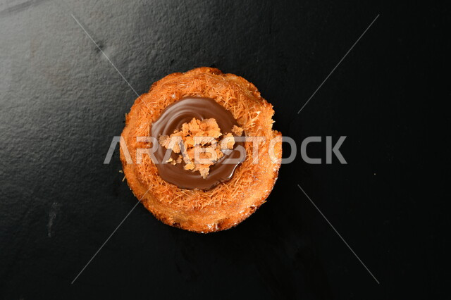 صورة من الأعلى لقطعة من الحلوى المزينة بالشوكولاتة، حلا القهوة، قطع الحلوى المحشوه بالشوكولاته، حلويات وسكريات، خلفيه سوداء