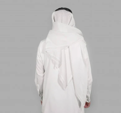 Portrait from the back of a Saudi Arabian Gulf man wearing traditional Saudi costume, white background