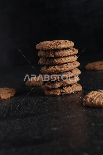 كعكات الشوكولاتة على طاولة خشبية ، رقائق الشوكولاته الساخنة  ، رقاقات البسكويت  مع قطع الشوكولاته الداكنة  ، كوكيز ، بسكويت ، حلويات مخبوزة.