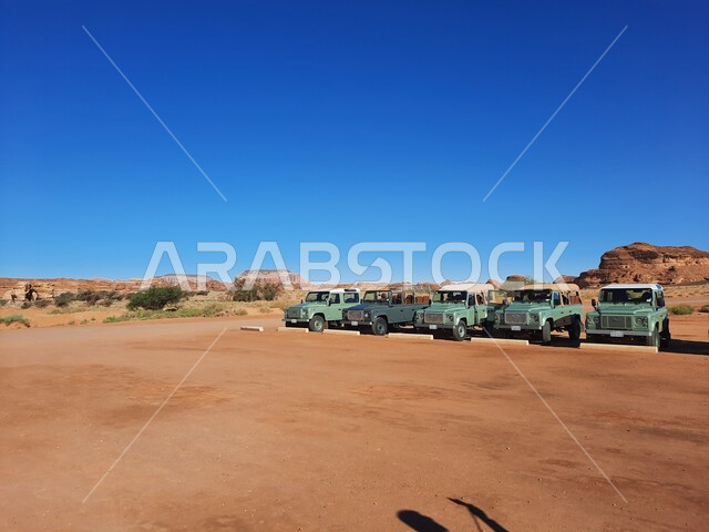A group of jeeps in Al-Ula Governorate, Saudi Arabia, rock formations, ancient historical monuments, rocky peaks and heights, desert nature, tourism in Saudi Arabia