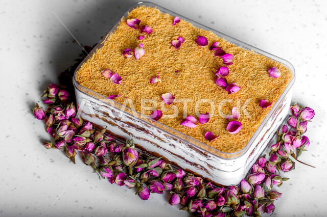 .A dish of Ramadan baklava cake decorated with flowers, oriental sweets, Ramadan sweets, sweets and sugars, delicious candy pieces, dessert, white background
