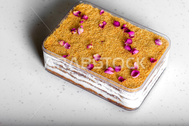 .A dish of Ramadan baklava cake decorated with flowers, oriental sweets, Ramadan sweets, sweets and sugars, delicious candy pieces, dessert, white background