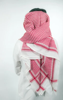 Portrait from the back of a Saudi Arabian Gulf man wearing traditional Saudi costume, white background