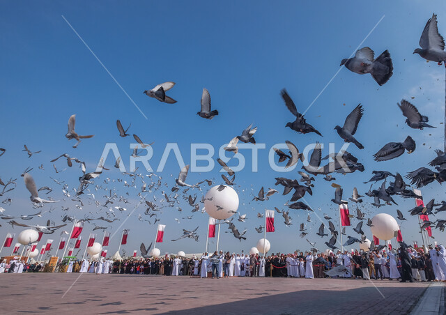 A group of pigeons flying high, celebrating the Qatari National Day, the National Day of the State of Qatar, the flags of the State of Qatar
