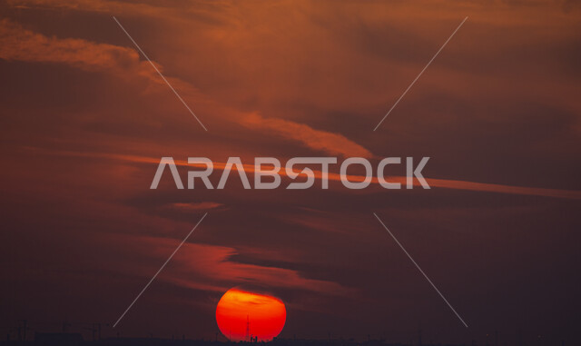 Red aurora, sun covered with clouds, sunset landscape, sunset background