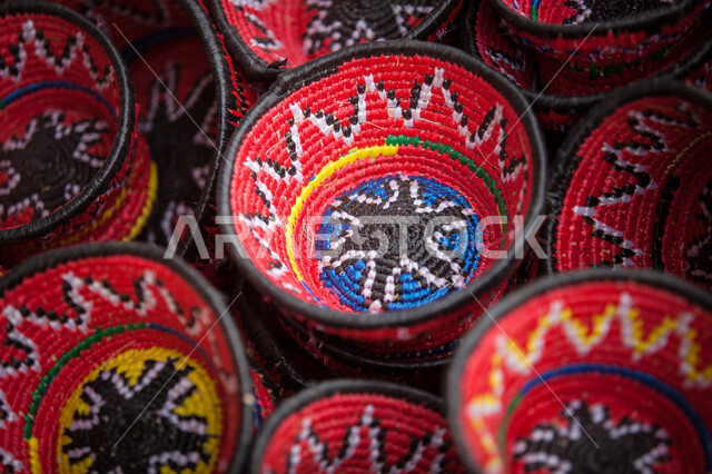 A close-up of a group of colorful wicker baskets, folk crafts and crafts, weaving wicker baskets, handicrafts, palm wicker.