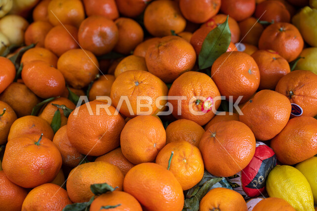 Close-up of the orange fruit section, shops, shopping inside the supermarket, buying household needs, commodities and various foodstuffs, consumer supplies.