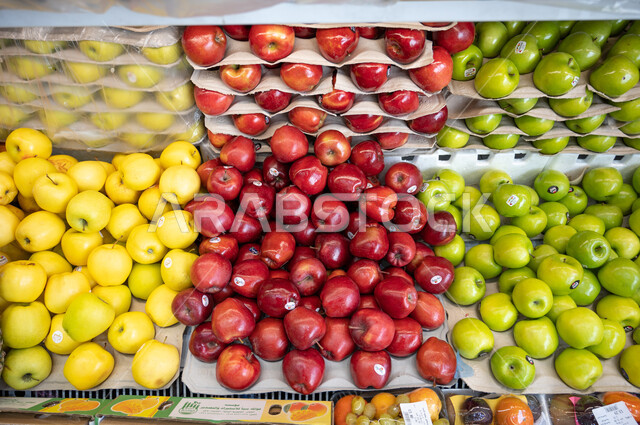 تصوير مقرب لفاكهة التفاح  داخل السوبرماركت  ، شراء الاحتياجات المنزلية ، السلع والمواد الغذائية المختلفة ، مستلزمات المستهلك ،  محلات تجارية.