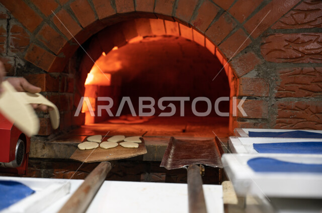 Close-up of pastries inside the oven, preparing baked goods and pastries, delicious fast food meals, Arab restaurants.