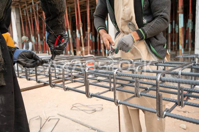 Close-up of a worker at a construction site, architectural development, architecture concept, building under construction, Saudi Arabia