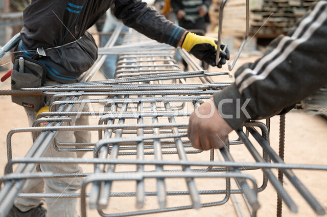 Close-up of a worker at a construction site, a building under construction, the concept of architecture, architectural development in the Kingdom of Saudi Arabia