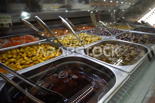 A group of olives in the supermarket, healthy meals, olives, commodities and foodstuffs, a snack, a variety of mixed cold appetizers.