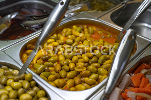  مجموعة من انواع الزيتون في المتجر، حبات الزيتون ، السلع والمواد الغذائية في السوبرماركت  ، تشكيلة من المقبلات الباردة المشكلة.