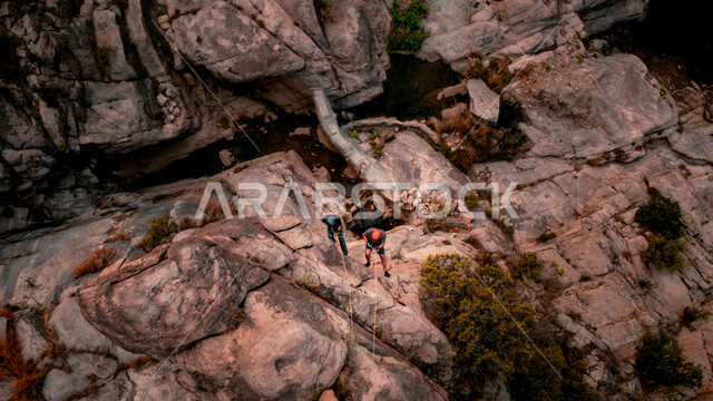 Two Saudi Arabian Gulf men practicing mountaineering, Tanuma Mountains in Asir, Saudi Arabia, Asir landmarks, rocky mountain climbing, mountain nature
