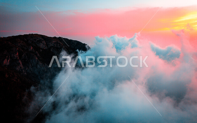 Al Soudah Mountains in Abha in Saudi Arabia at sunset, white clouds and clouds, mountain peaks, mountains and heights, mountainous terrain, landscapes, nature background, tourism in Saudi Arabia