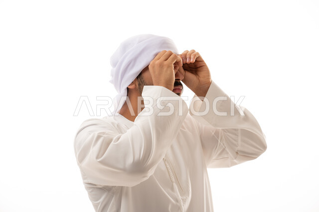 Portrait of an Arab Emirati Gulf man in traditional attire, making different facial gestures, hand signals clearly indicating vision, future goals, focusing on something, a white background