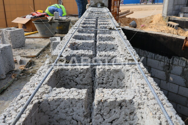 Building a brick and cement wall, brick mold, masonry work, stone wall, construction tools and equipment