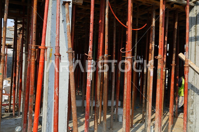 Close-up of floor building columns, solid iron columns, construction tools and equipment, floor building support columns, architectural development, construction work