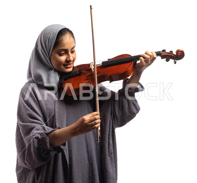 Portrait of a Saudi Gulf Arab female artist playing the violin, musical ...