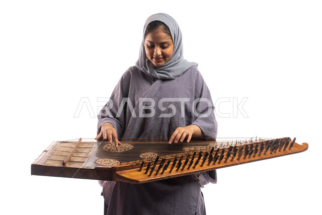 Musical artistic talents, a portrait of a Saudi Arabian Gulf woman, an artist playing the qanun, presenting programs and musical arts and theatrical art, using stringed musical instruments, practicing Saudi folk arts, white background