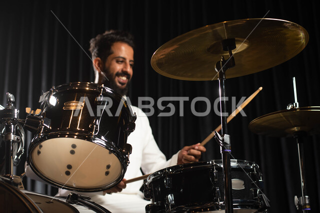 Musical artistic talents, an Arab Saudi Gulf artist who practices the hobby of drumming on an electronic drum machine, drumming using percussion instruments, presenting programs, musical arts and theatrical art, entertainment activities