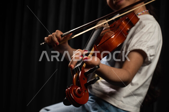 Musical artistic talents, practicing the hobby of playing the violin, a ...