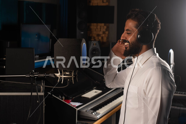 رجل خليجي سعودي عربي فنان داخل استديو التسجيل الصوتي، مواهب فنية موسيقية، الاستمتاع بتقديم البرامج والفنون الموسيقية والفن المسرحي، الاذاعة الصوتية والغناء والطرب
